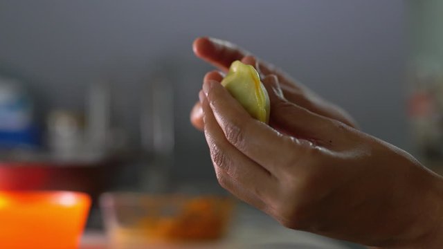 Side view of asian female folding Malay pastry curry puff or Karipap. Selective focus