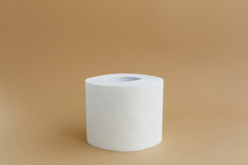 roll of white toilet paper on a brown background