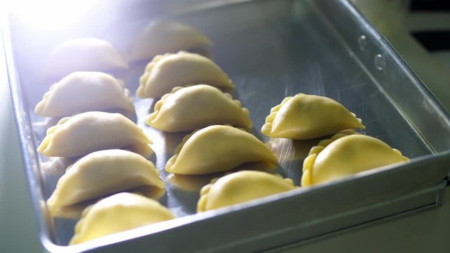 Top view of asian female organizing Malay pastry curry puff or Karipap. Selective focus
