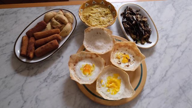 Homemade srilankan dishes, egg hopper,samosas and eggplantts with sugar and curry