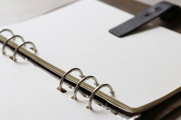 Close up open notebook with blank paper on wooden desk