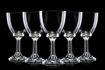 Set of empty glasses of light beer with foam isolated on a black background