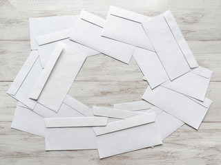 White envelopes are scattered on the table