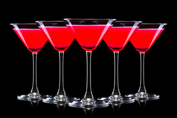 Set of strawberry margarita cocktail in martini glasses isolated on black