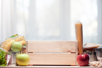 Donation box with food adainst window.