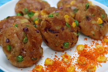 Crunchy bread cultlets, vegetables, corn and peas