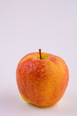 Fresh apple with water drops isolated on white background. Close-up
