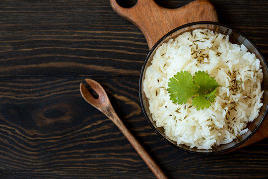 spiced rice top view on wooden table with spoon