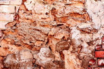 Texture of a brick wall with cracks and scratches which can be used as a background