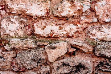 Texture of a brick wall with cracks and scratches which can be used as a background