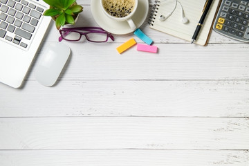 White wood desk table with laptop computer and coffee  on white wood