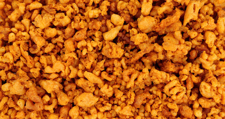 Batter scraps background texture, also known as batter bits or dubs, they are pieces of deep-fried...