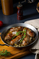 Homemade white sausage fried with onion and herbs