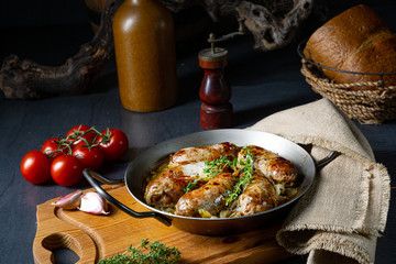 Homemade white sausage fried with onion and herbs
