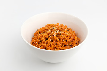 Stir-fried noodles with hot sauce in the background