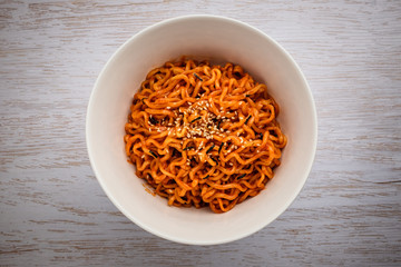 Stir-fried noodles with hot sauce in the background