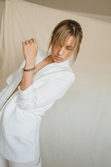Sensual portrait of a young attractive woman in a white blazer.