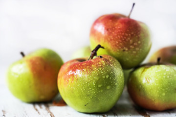 red and green apples on the table close-up, soft focus