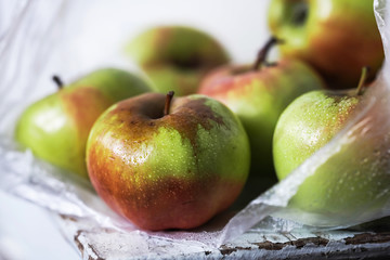 yellow-red apples in a plastic bag close-up on a light background