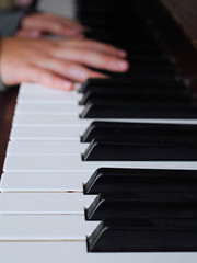 Fototapeta premium Practicing on piano, Teenager's hand, black and white keys, Concept developing finger's motion skill,