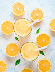Orange juice in glass, fresh fruits on wooden background