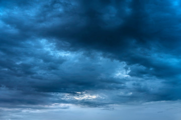 Naklejka na ściany i meble Storm evening dark blue clouds. Sunset