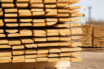 Edged boards in stock, ready for sale. Warehouse of construction materials.