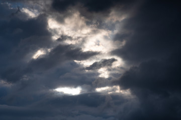 Storm clouds. The sky before a thunderstorm. Rays of the sun through dark thunderclouds