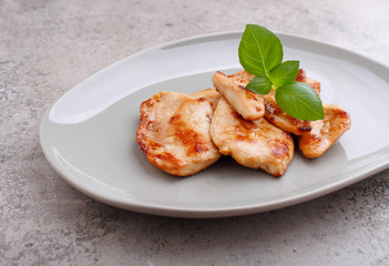 Fried chicken with soy sauce on a plate decorated with sesame seeds