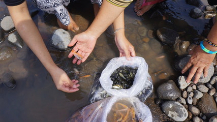 two women and small fish found in 2 plastic packages on the river bank