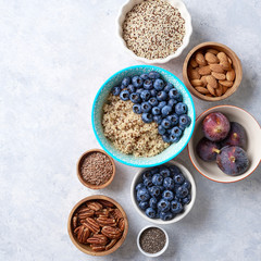 Healthy breakfast of superfoods, quinoa, honey, nuts, figs, coffee. Top view