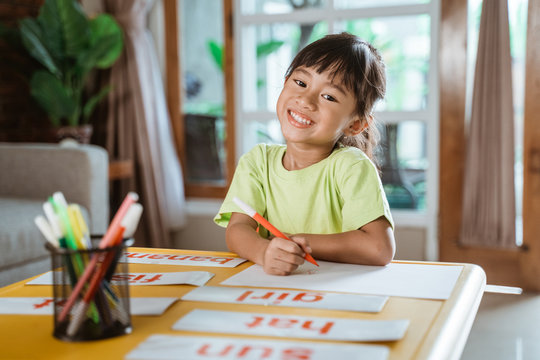 Independent Kid Learning At Home Doing Some Homework. Toddler Asian Student