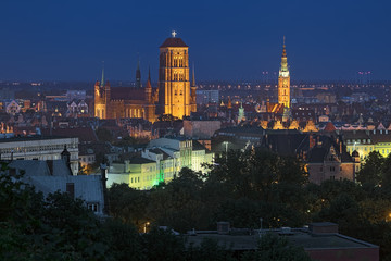 Fototapeta na wymiar Gdansk, Poland. St. Mary's Church and tower of Main Town Hall in dusk. View from Gradowa Hill.