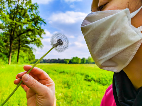 05/06/2020 Italy: Woman trying to blow on a dandelion with a mask. Due to the lockdown even the esyest act of oll the days are difficult and it's hard to feel free and return to the normal life