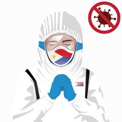 Covid-19 or Coronavirus concept. Filipino medical staff wearing mask in protective clothing and praying for against Covid-19 virus outbreak in Philippines. Filipino man and Philippines flag. Pandemic