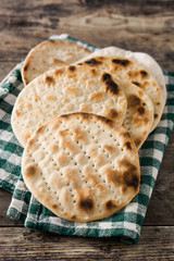 Handmade matzah for Jewish Passover on wooden table. 