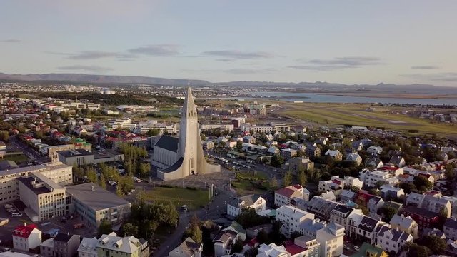 Sunset drone flight in Reykjavik, Iceland with city and cathedral.