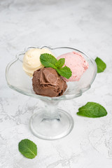 Three balls of ice cream in a transparent glass