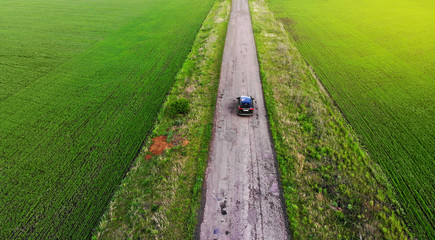 Aerial. Car motion along the rural road. Local tourism by car idea.