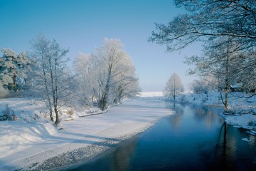 River in Winter with frosted trees near it