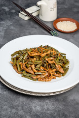 Roasted fern salad with meat in a white plate