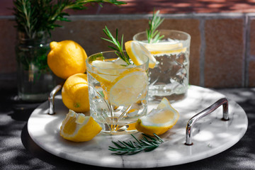 Lemonade, lemon mojito cocktail, cold, iced,refreshing summer drink in glasses with slices of lemon...