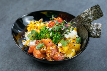 Salmon poke with pickled cucumber, carrots, avocado and seaweed