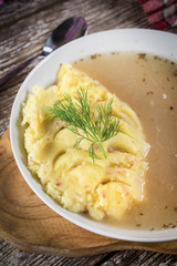 Pure white borscht served with mashed potatoes.