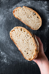 Dark mood and tone Home Cooking Homemade Organic rustic Sourdough bread on black background with...