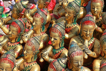 Fototapeta premium A collection of golden female Buddhist statues playing musical instruments