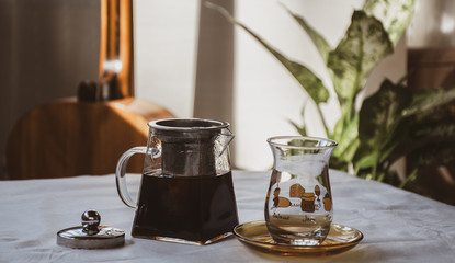 soft pastel scene of a glass teapot with hot tea and classic turkish tea glass on the table © mitre