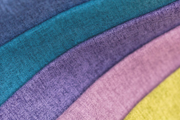 Samples of multi-colored furniture fabric laid in convolutions. Tissue industry.