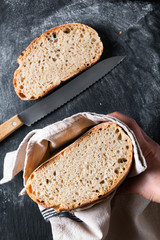 Dark mood and tone Home Cooking Homemade Organic rustic Sourdough bread on black background with copy space