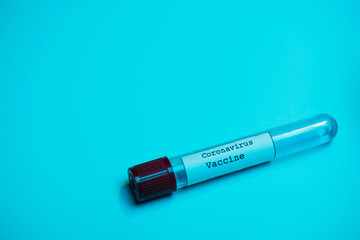 High angle view of test tube with coronavirus vaccine on blue
